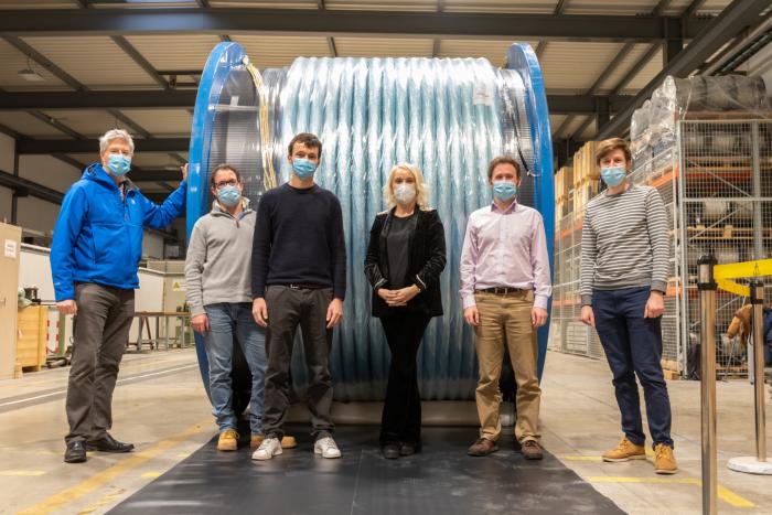 WP6a team in front of the 120 kA, 140 m long MgB₂ transmission cable that will power the HL-LHC triplets (Image: CERN)