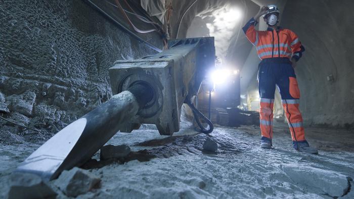 hl-lhc worker at 80 meters underground in a dimly lit tunnel undergoing a noisy excavation.