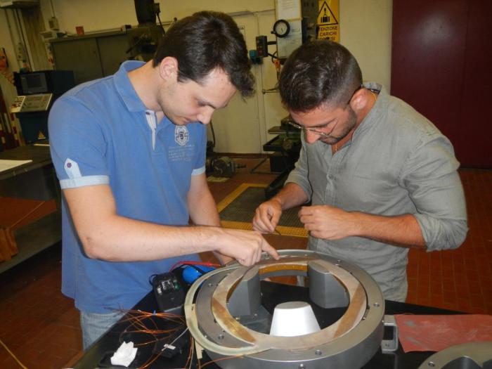 Assembly of the MgB2 superconducting coils in the iron pole and yoke.