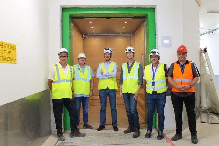 CERN and Schindler representatives next to the brand-new lift (Image: Irene Garcia Obrero)