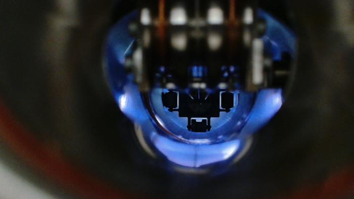 black background with close-up view of equipment in a blue light
